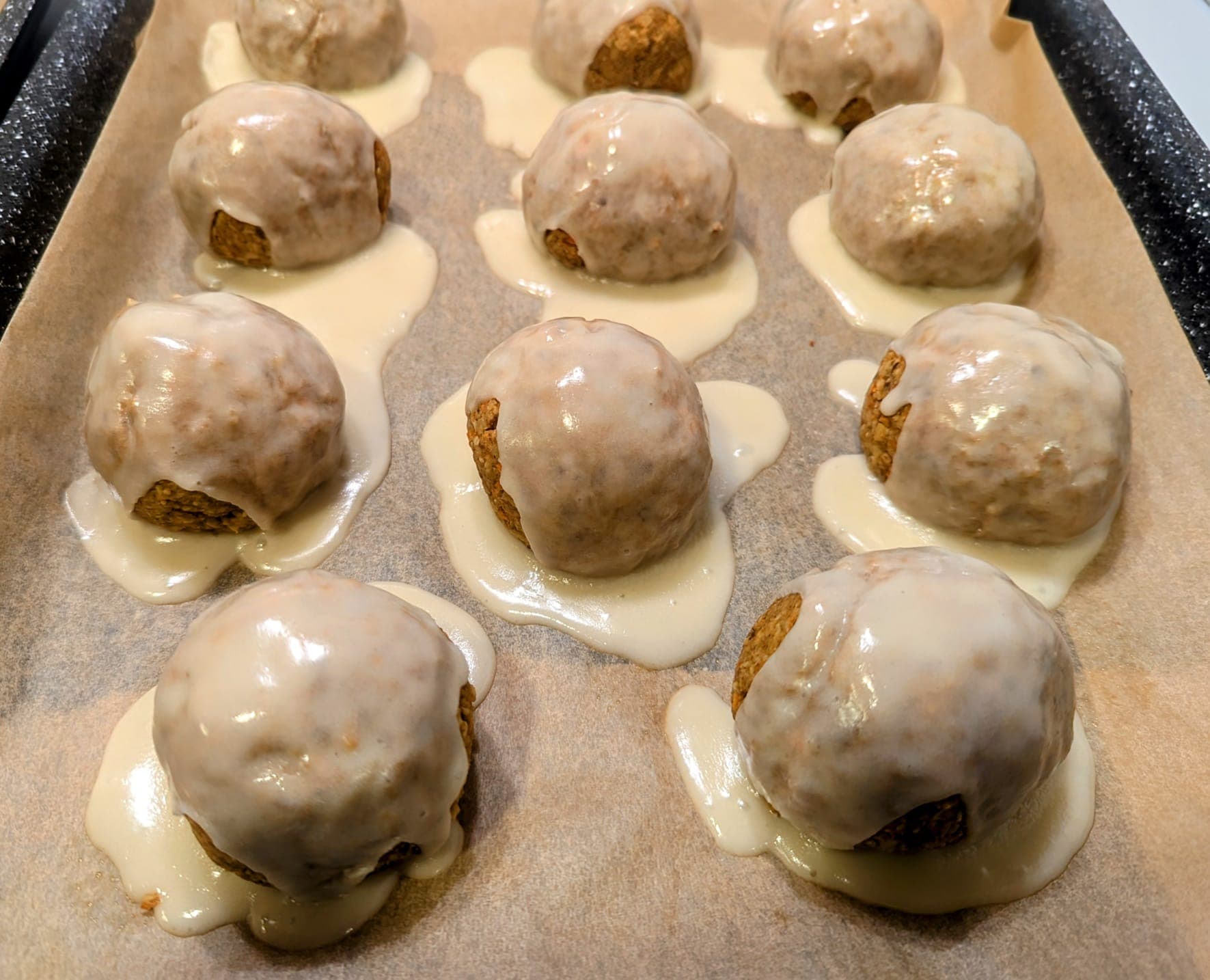 Vegan oat carrot cake balls with carrots, nut butter, walnuts, and optional dairy-free frosting, a soft sweet snack.